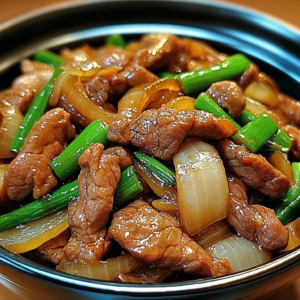 savory soy-ginger beef with caramelized onions served over rice