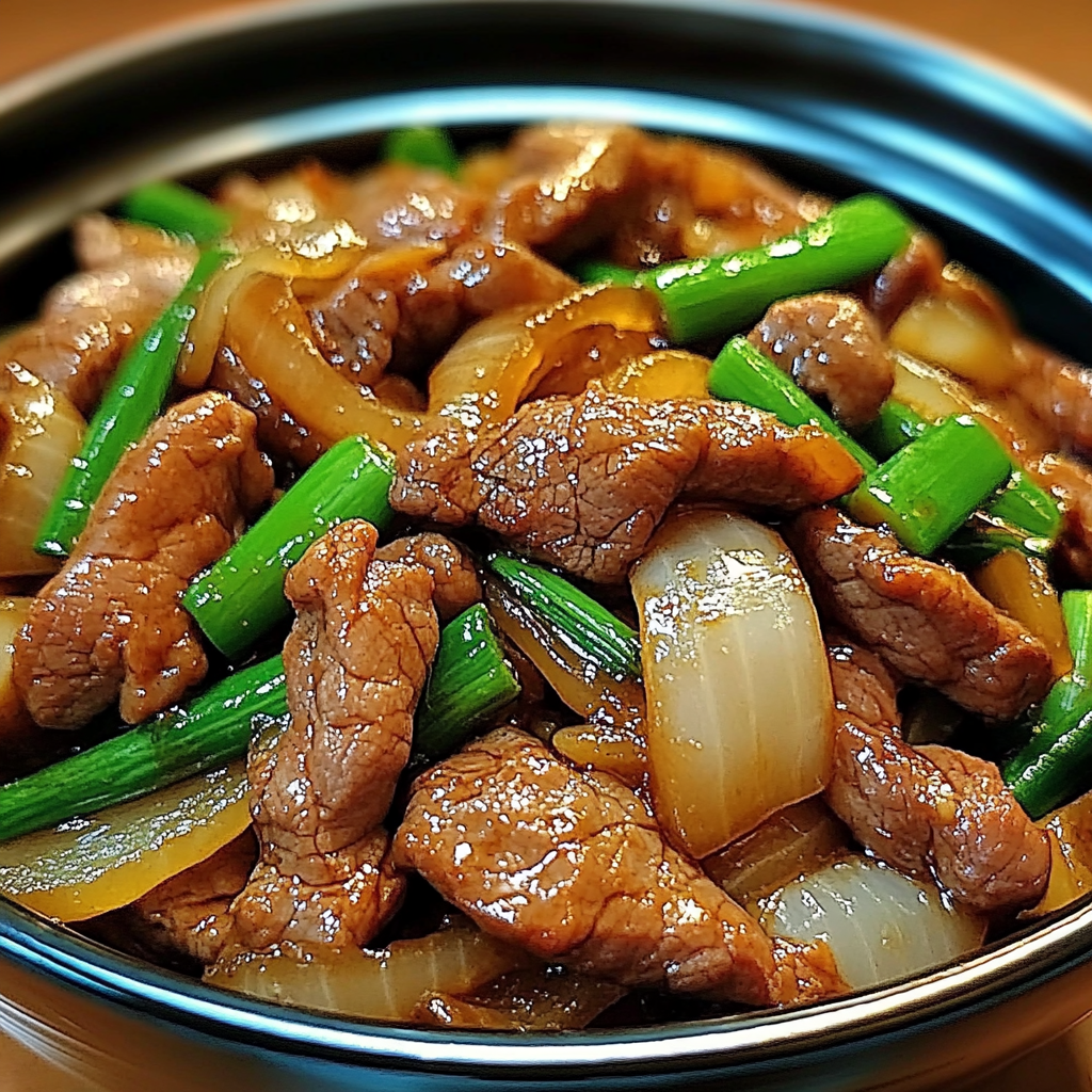savory soy-ginger beef with caramelized onions served over rice