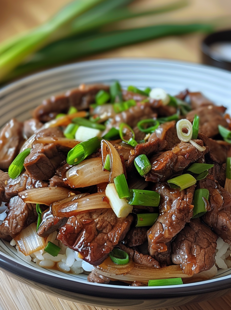 Savory beef stir-fry with sweet onions and aromatic sauce close-up