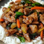 Overhead view of Spicy Thai Basil Beef with Garlic, Peppers & Jasmine Rice, showing vibrant red bell peppers, fresh green Thai basil leaves, and steaming jasmine rice